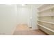 Practical laundry area with a washer, dryer, and ample shelving for storage at 15758 W Cortez St, Surprise, AZ 85379