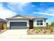 Charming single-story home featuring a two-car garage, stone accents, and low maintenance desert landscaping at 1706 N Camden Dr, Florence, AZ 85132