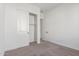 Bright bedroom featuring neutral carpet, white walls, and a closet with sliding doors at 21829 E Bonanza Ct, Queen Creek, AZ 85142