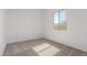 A sunny bedroom featuring neutral carpet and white walls, enhanced by natural light at 21829 E Bonanza Ct, Queen Creek, AZ 85142