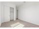 Bright bedroom with neutral carpet, white walls, and a closet with sliding doors for ample storage at 21829 E Bonanza Ct, Queen Creek, AZ 85142