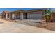 Inviting home featuring stone veneer accents, covered entryway, and a convenient two-car garage at 21829 E Bonanza Ct, Queen Creek, AZ 85142