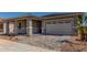 Beautiful home showing a two car garage, with stone detail on the front columns and covered entryway at 21829 E Bonanza Ct, Queen Creek, AZ 85142