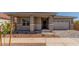Charming home exterior featuring stone accents, covered porch, and a two-car garage at 21829 E Bonanza Ct, Queen Creek, AZ 85142