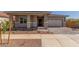 Charming single-story home with a well-manicured yard and inviting stone-accented facade at 21829 E Bonanza Ct, Queen Creek, AZ 85142