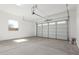 Spacious two-car garage featuring a large roll up door and room for storage at 21829 E Bonanza Ct, Queen Creek, AZ 85142