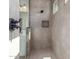 Sleek tiled shower with built-in niche and modern fixtures in a bathroom setting at 21829 E Bonanza Ct, Queen Creek, AZ 85142