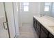Modern bathroom featuring a glass-enclosed shower and a vanity with double sinks at 2442 W Rowel Rd, Phoenix, AZ 85085