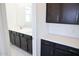 Bathroom with dark cabinets, white countertops and a large mirror for elegance at 2442 W Rowel Rd, Phoenix, AZ 85085