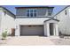 Charming two-story home featuring gray and white paint, brick driveway, and attached two car garage at 2442 W Rowel Rd, Phoenix, AZ 85085