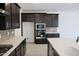 Well-equipped kitchen with dark wood cabinets, stainless steel appliances, tile backsplash, and white countertops at 2442 W Rowel Rd, Phoenix, AZ 85085