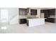 Open concept kitchen with dark wood cabinets, stainless steel appliances, and a large kitchen island at 2442 W Rowel Rd, Phoenix, AZ 85085