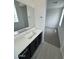 Modern bathroom featuring a sleek vanity, framed mirror, and stylish tile flooring at 2470 W Rowel Rd, Phoenix, AZ 85085