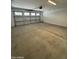 Garage featuring concrete floor and overhead garage door with windows at 2470 W Rowel Rd, Phoenix, AZ 85085