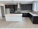 Modern kitchen features stainless steel appliances, gray backsplash, a center island, and dark cabinets at 2470 W Rowel Rd, Phoenix, AZ 85085