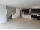 Open-concept living space features stairs, recessed lighting, and flows into a modern kitchen at 2470 W Rowel Rd, Phoenix, AZ 85085