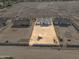 Aerial view of the new construction homes and a large, empty plot awaiting construction with equipment on it at 26536 S 188Th Pl, Queen Creek, AZ 85142