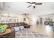 Open-concept living area with a cozy rug, leather sofa, and seamless flow into the adjacent kitchen at 3547 N 145Th Ave, Goodyear, AZ 85395