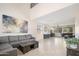 Spacious living room with neutral tile flooring, large sectional sofa, and modern artwork at 3547 N 145Th Ave, Goodyear, AZ 85395