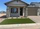 Charming single-Gathering home featuring a two-car garage and an inviting front porch with stone accents at 3638 E Roland St, Mesa, AZ 85213