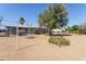 Expansive backyard with desert landscaping and mature shade tree at 5455 E Baltimore St, Mesa, AZ 85205