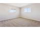 Bright, carpeted bedroom with dual windows providing plenty of natural light at 5455 E Baltimore St, Mesa, AZ 85205