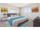 Cozy bedroom featuring a stylish bed, ample natural light, and decorative artwork at 5455 E Baltimore St, Mesa, AZ 85205