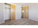 Bedroom with two closets and a view to another room, maximizing space and functionality at 5455 E Baltimore St, Mesa, AZ 85205