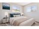 Bedroom with a bed, dual windows, stylish lamps, and sleek nightstands at 5455 E Baltimore St, Mesa, AZ 85205