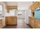 Cozy kitchen with wood cabinets, white appliances, and a connecting dining area at 5455 E Baltimore St, Mesa, AZ 85205