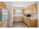 Well-lit kitchen featuring wood cabinets, a window above the sink, and modern appliances at 5455 E Baltimore St, Mesa, AZ 85205