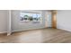 Bright living room featuring hardwood floors, a large window, and a view of the neighborhood at 5455 E Baltimore St, Mesa, AZ 85205