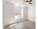 This bright bedroom features a ceiling fan, a window, and light colored wood flooring at 1165 E Avenida Kino --, Casa Grande, AZ 85122