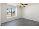 This bright bedroom features a ceiling fan, a window, and wood-look tile flooring at 1165 E Avenida Kino --, Casa Grande, AZ 85122