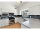Well-lit kitchen featuring stainless steel appliances and tile backsplash at 1165 E Avenida Kino --, Casa Grande, AZ 85122