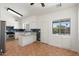 Bright kitchen with stainless steel appliances, ample white cabinetry, tile floors, and a backyard view at 1165 E Avenida Kino --, Casa Grande, AZ 85122