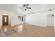 Open living room featuring tile flooring, neutral walls, arched doorways, and a window with a view of the front yard at 1165 E Avenida Kino --, Casa Grande, AZ 85122