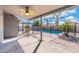 Large covered patio with ceiling fan overlooks the sparkling backyard pool and mature landscaping at 1165 E Avenida Kino --, Casa Grande, AZ 85122