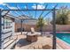 Covered backyard patio with seating area, outdoor fire pit, and a view of the pool at 1165 E Avenida Kino --, Casa Grande, AZ 85122