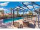Backyard pool featuring covered patio, desert landscaping, and an outdoor fire pit at 1165 E Avenida Kino --, Casa Grande, AZ 85122
