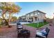 Spacious backyard featuring a pool, fire pit, turf lawn, and comfortable lounge chairs at 12229 N 121St Dr, El Mirage, AZ 85335