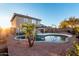 Wonderful backyard pool with palm trees, lounge area, and playset at 12229 N 121St Dr, El Mirage, AZ 85335