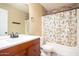 Updated bathroom with stylish vanity, decorative shower curtain, and stone accent wall at 12229 N 121St Dr, El Mirage, AZ 85335