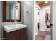 Well lit bathroom with wood floors, cabinets, and a closet at 12229 N 121St Dr, El Mirage, AZ 85335