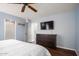 Bright bedroom with blue walls, dark wood floors and a view to the bathroom at 12229 N 121St Dr, El Mirage, AZ 85335