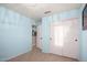 Bright bedroom with light blue walls, closet, carpet, and view into hall at 12229 N 121St Dr, El Mirage, AZ 85335