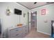 Charming bedroom with a gray dresser, mounted TV, and whimsical decorations at 12229 N 121St Dr, El Mirage, AZ 85335