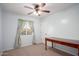 This bedroom offers bright walls, carpet and a beautiful writing desk at 12229 N 121St Dr, El Mirage, AZ 85335
