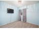 This is a bedroom with light blue walls, wall mounted tv, and carpet at 12229 N 121St Dr, El Mirage, AZ 85335
