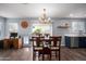 Dining room features modern chandelier and sliding glass door to backyard at 12229 N 121St Dr, El Mirage, AZ 85335